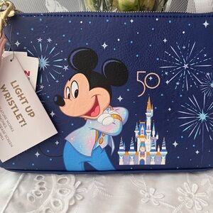 Disney 50 to Anniversary Wristlet NWT lights up when your cell phone activates.